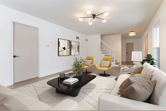 a living room with furniture and a potted plant