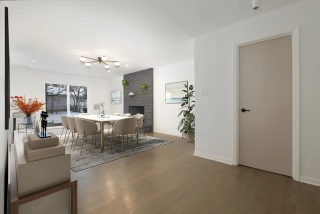 a view of a dining room with furniture and chandelier