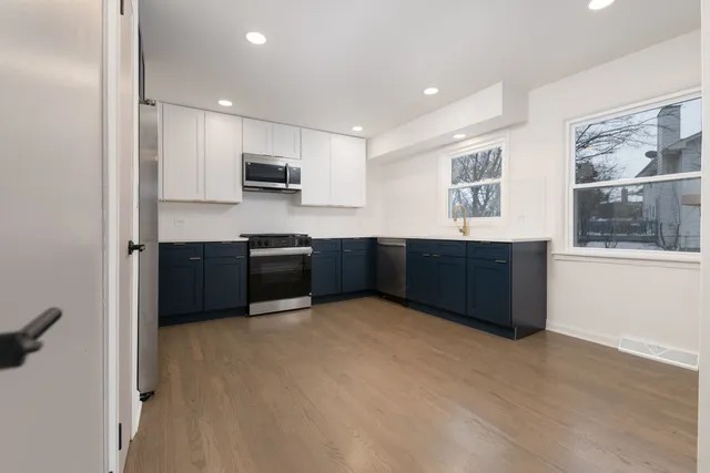 a kitchen with stainless steel appliances a sink and a microwave