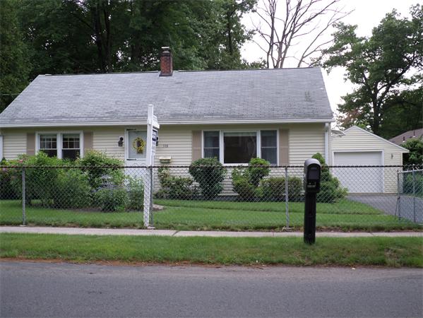 a front view of house with a garden