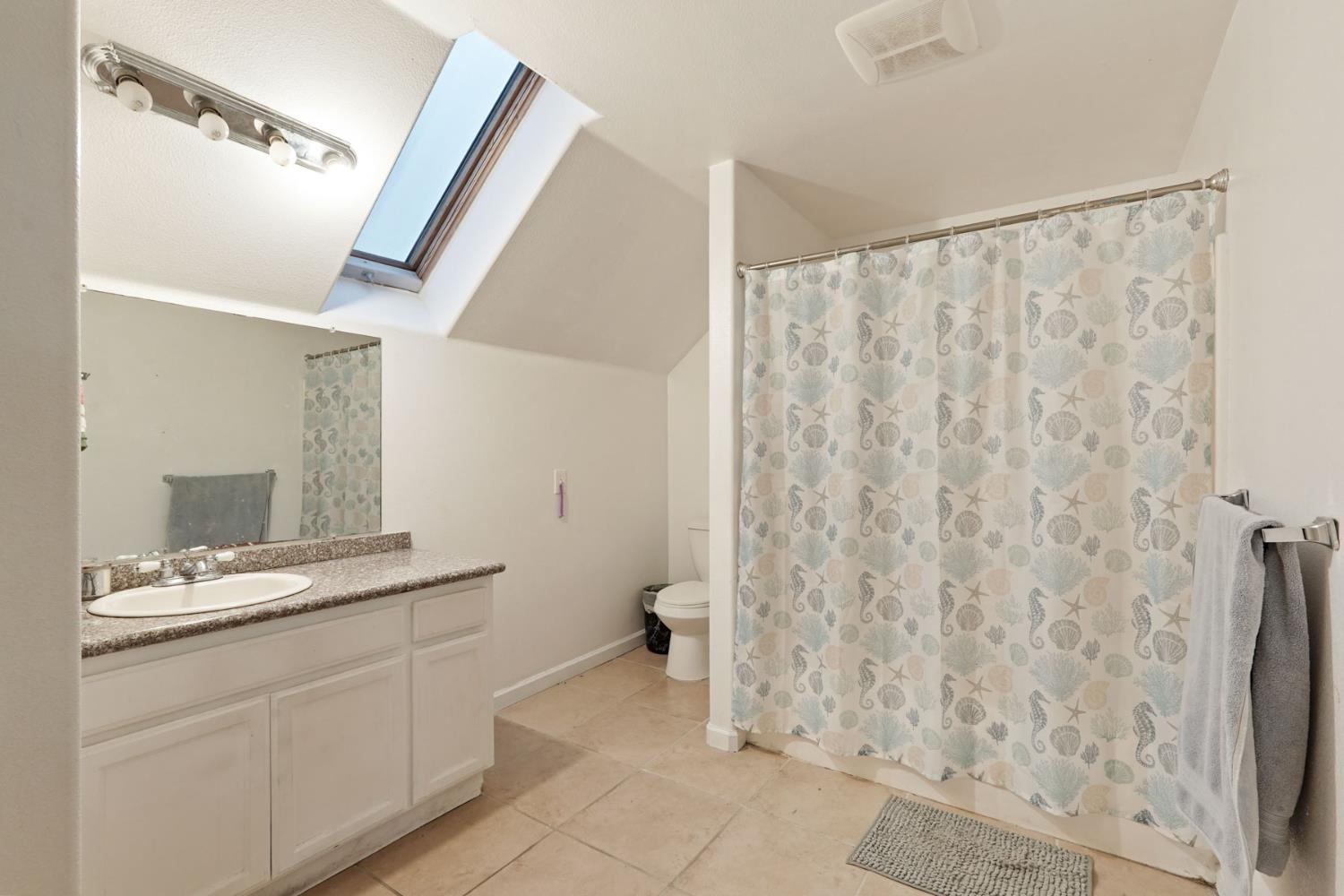 336 Locust Street Lodi, CA 95240 - Photo 12 of 31 a bathroom with a granite countertop sink and a mirror