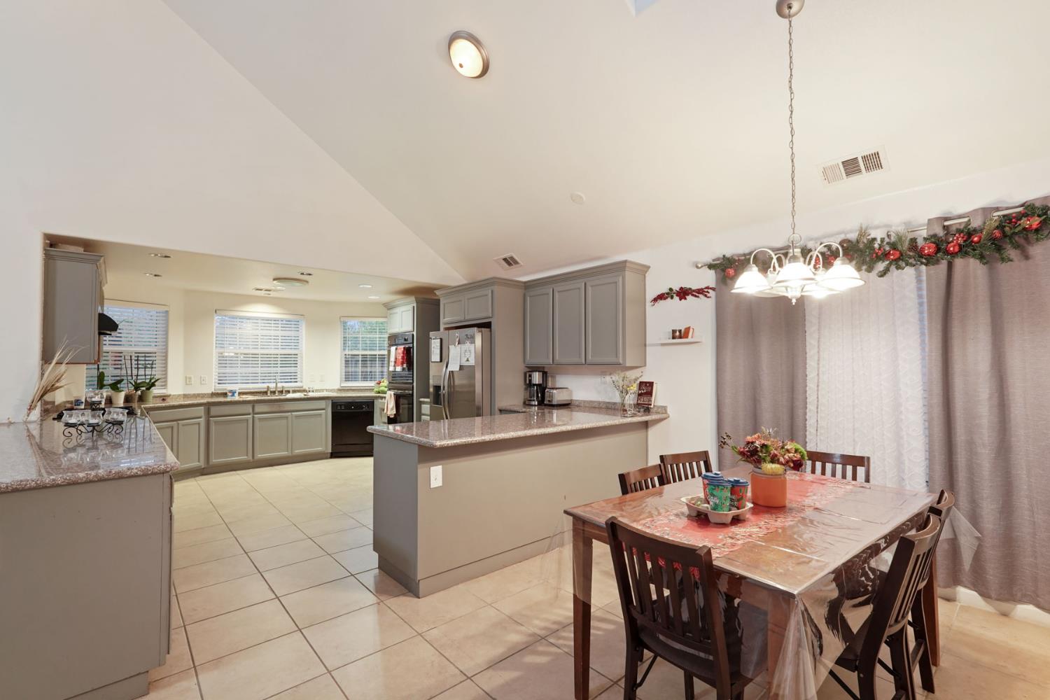 336 Locust Street Lodi, CA 95240 - Photo 17 of 31 a kitchen with kitchen island a sink table and chairs