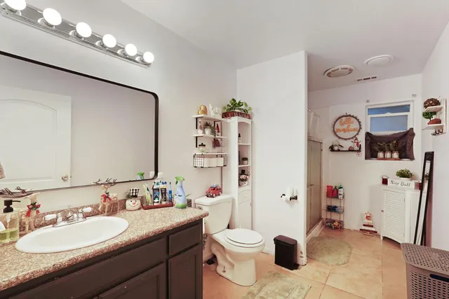 a bathroom with a sink a toilet and shower curtain