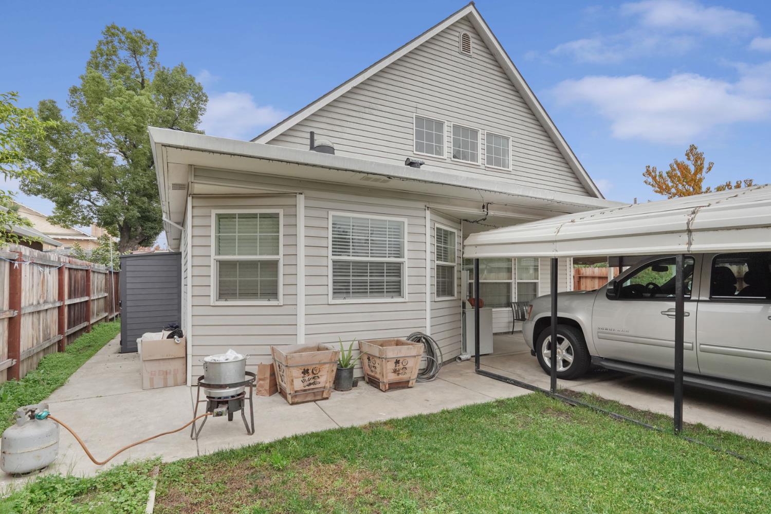 336 Locust Street Lodi, CA 95240 - Photo 4 of 31 a view of a house with a backyard and a patio