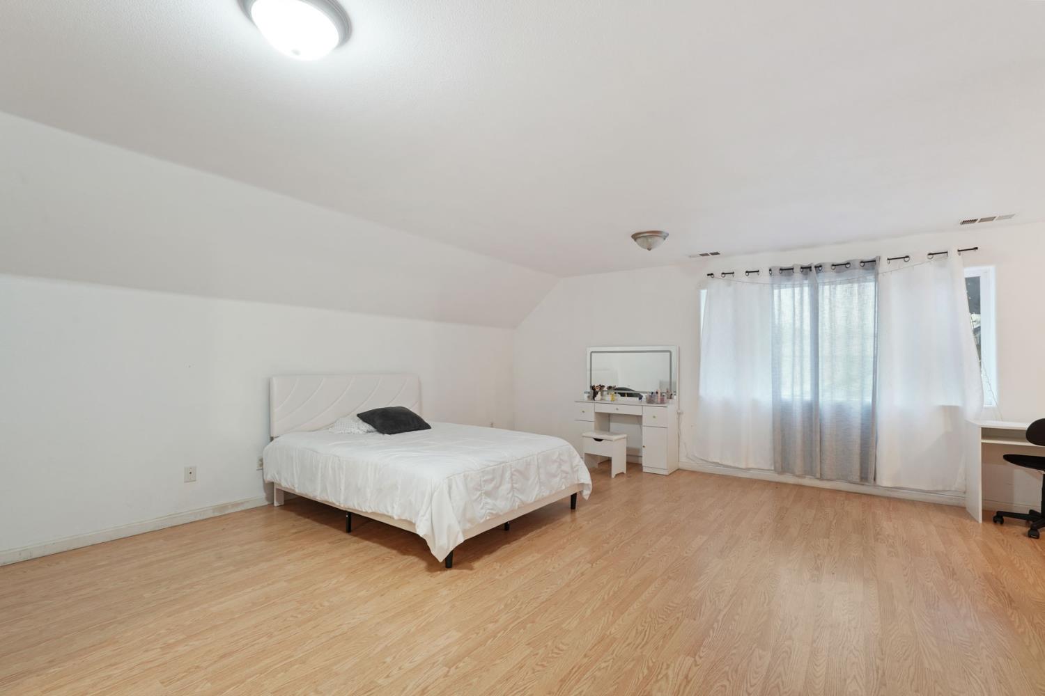 336 Locust Street Lodi, CA 95240 - Photo 9 of 31 a bedroom with a bed and a window