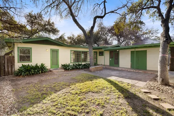a view of a backyard with a large tree