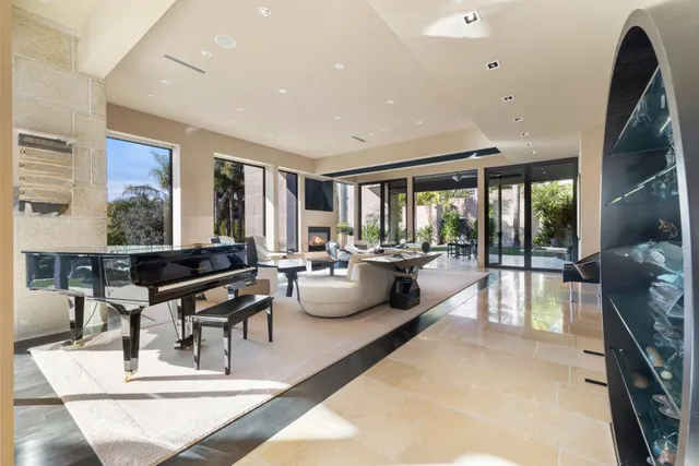 a living room with furniture a large window and a table