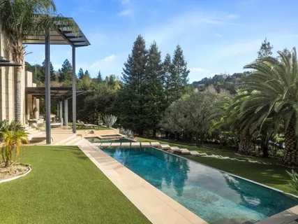 a view of a swimming pool and lounge chairs