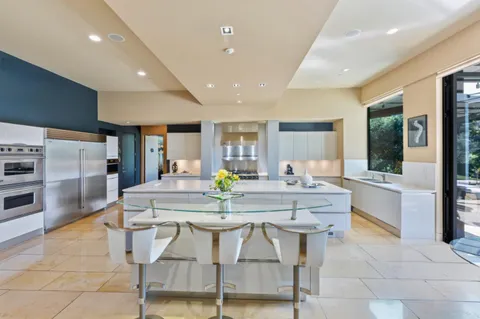 a bedroom with a large bed and a large window