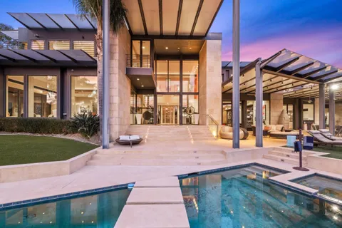a view of a house with backyard porch and sitting area
