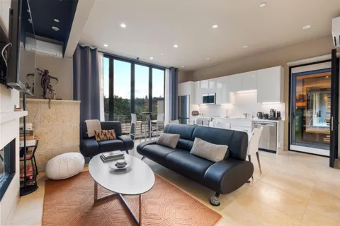 an aerial view of residential houses with outdoor space and trees