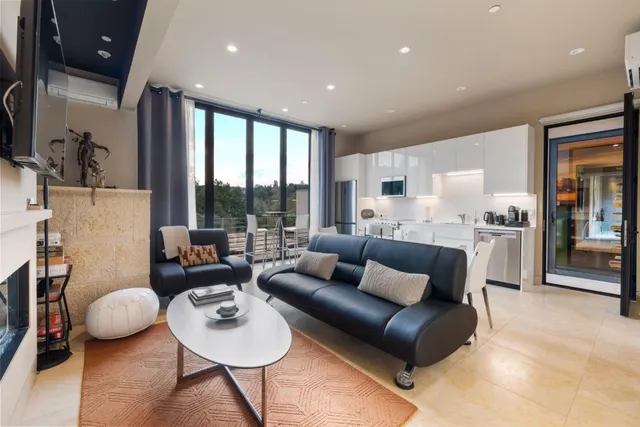 an aerial view of residential houses with outdoor space and trees