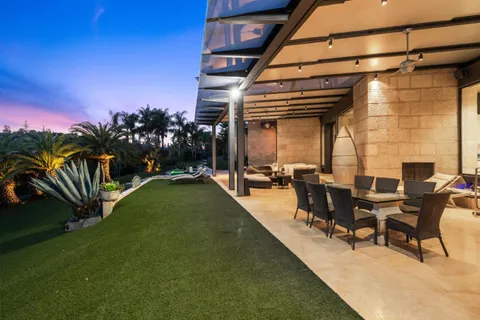 a view of a swimming pool with outdoor seating and plants