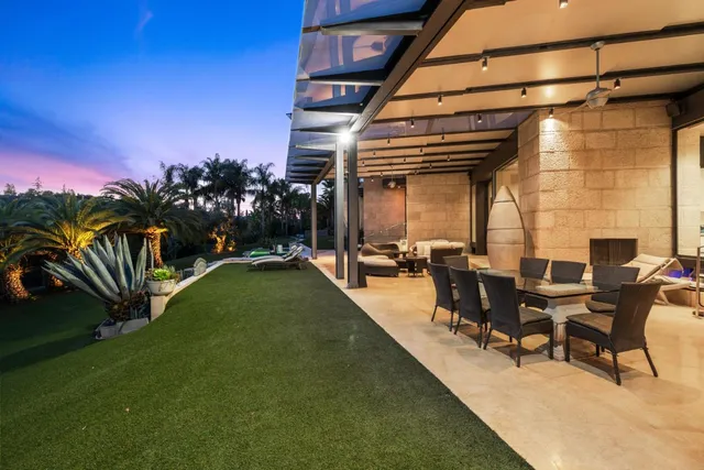 a view of a swimming pool with outdoor seating and plants
