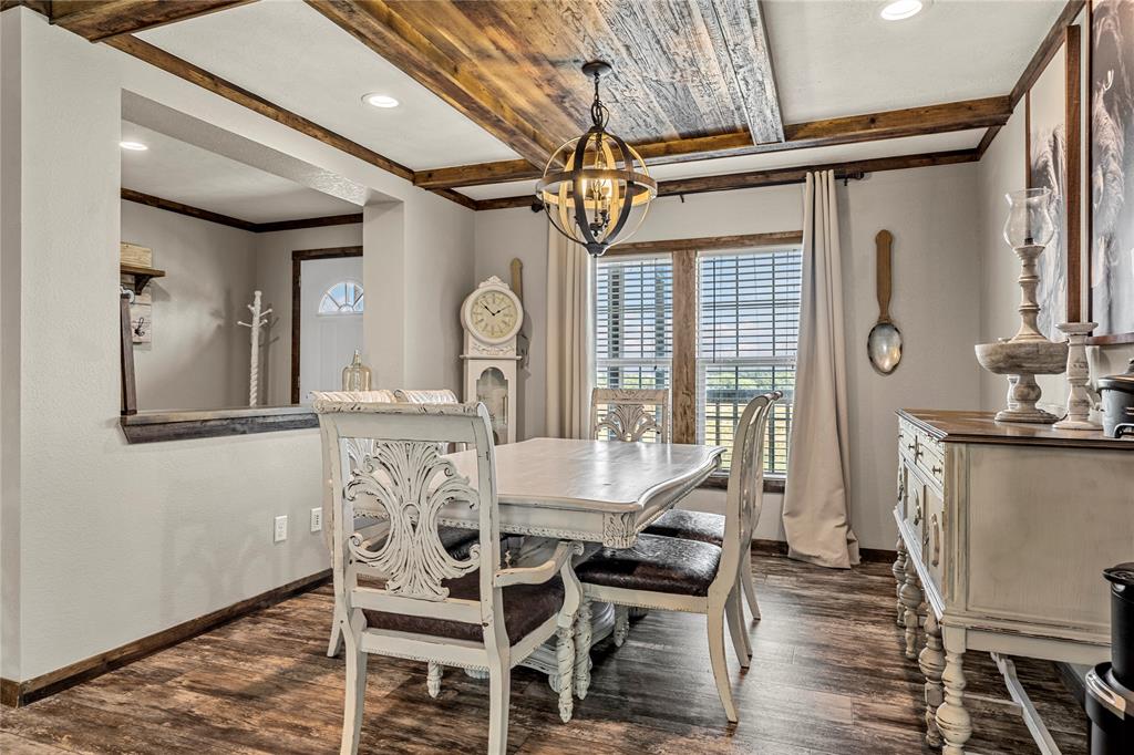 602 3rd Street Abbott, TX 76621 - Photo 11 of 40 Dining area featuring wood-finish flooring and a decorative wood ceiling with exposed beams