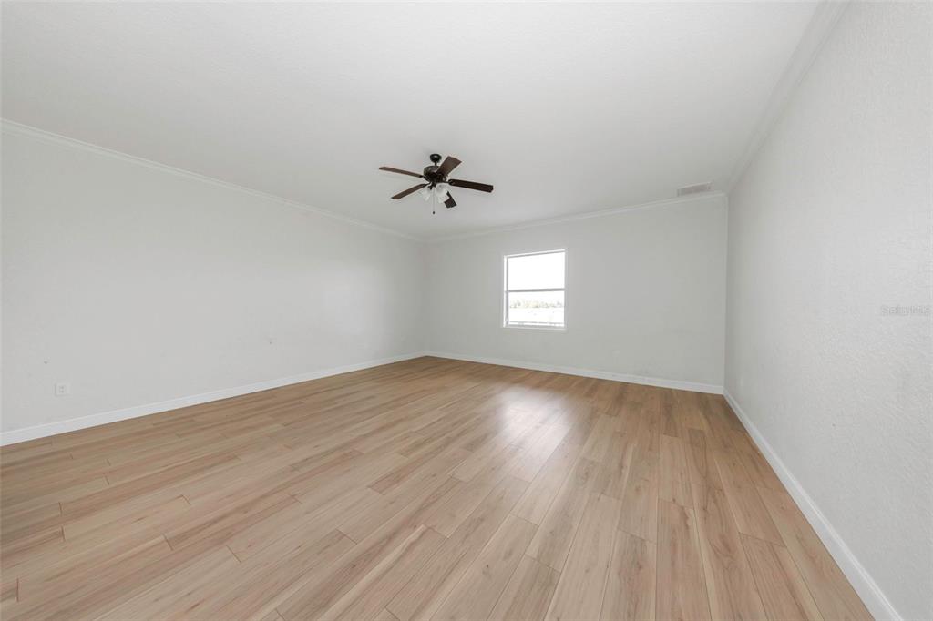 20138 Bowman Road Spring Hill, FL 34610 - Photo 37 of 40 wooden floor in an empty room with a window