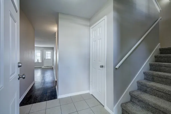 a view of a hallway with wooden floor and staircase