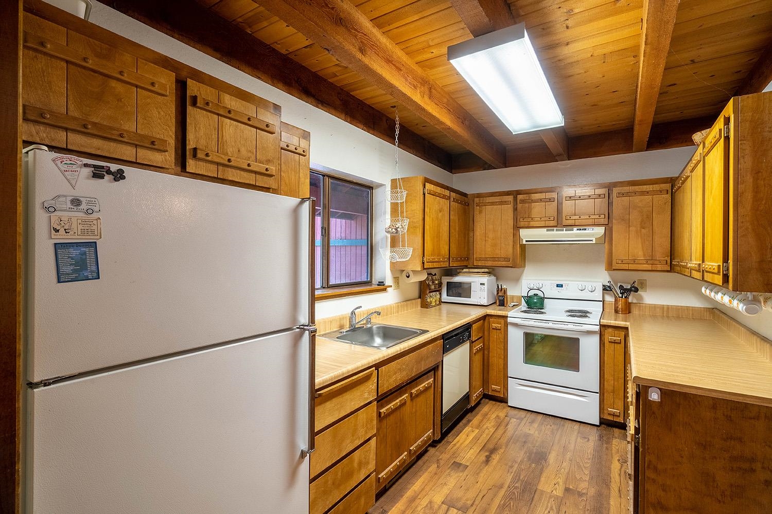 12119 Brookstone Drive Truckee, CA 96161 - Photo 9 of 21 a kitchen with stainless steel appliances granite countertop a refrigerator a stove a sink dishwasher and a refrigerator with wooden floor