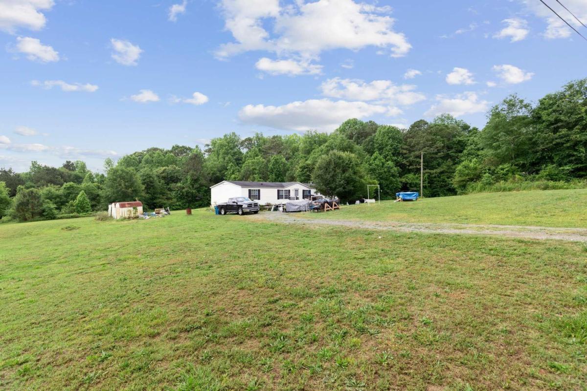 66 Tanners Bridge Road Bethlehem, GA 30620 - Photo 1 of 1 a house view with swimming pool and trees in the background