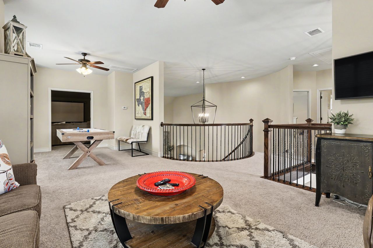 809 Prairie Dunes Drive Georgetown, TX 78628 - Photo 24 of 40 A spacious recreation room offers comfortable carpeting, ideal for a relaxed gathering space.
