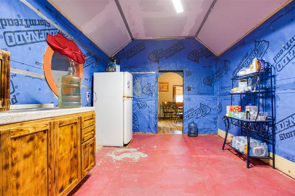 1303 North 7th Street Ballinger, TX 76821 - Photo 19 of 26 a dining room with furniture and a fireplace