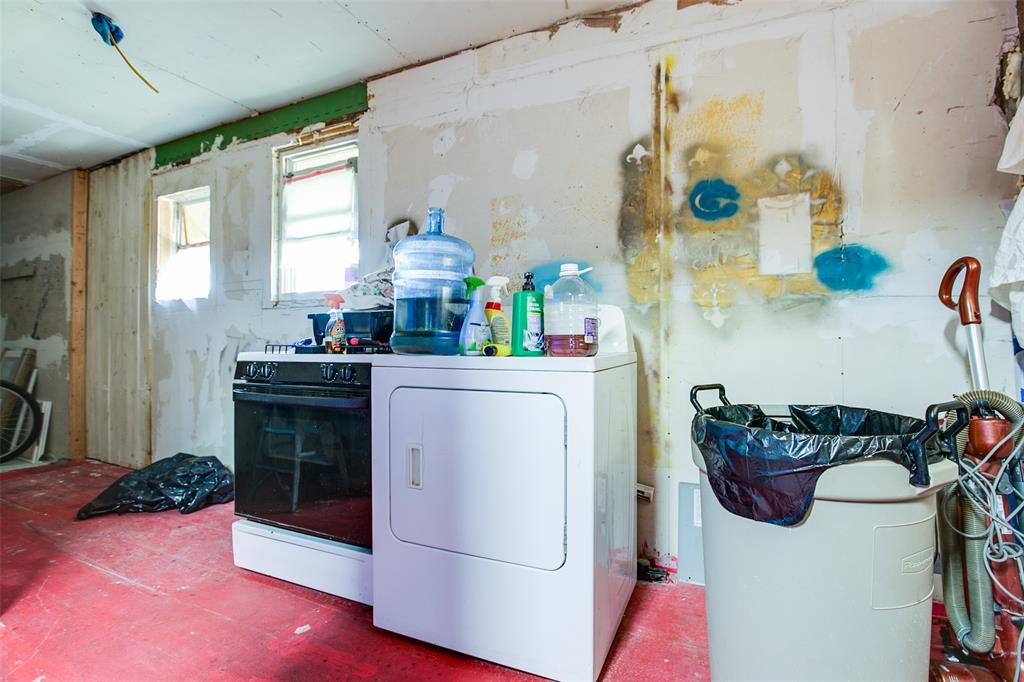 1303 North 7th Street Ballinger, TX 76821 - Photo 20 of 26 a kitchen with a refrigerator and stove