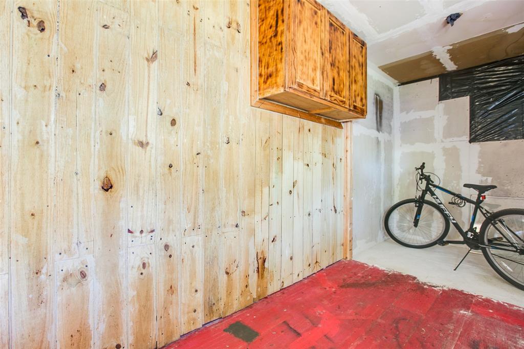 1303 North 7th Street Ballinger, TX 76821 - Photo 22 of 26 a bedroom with a bed a desk and a mirror
