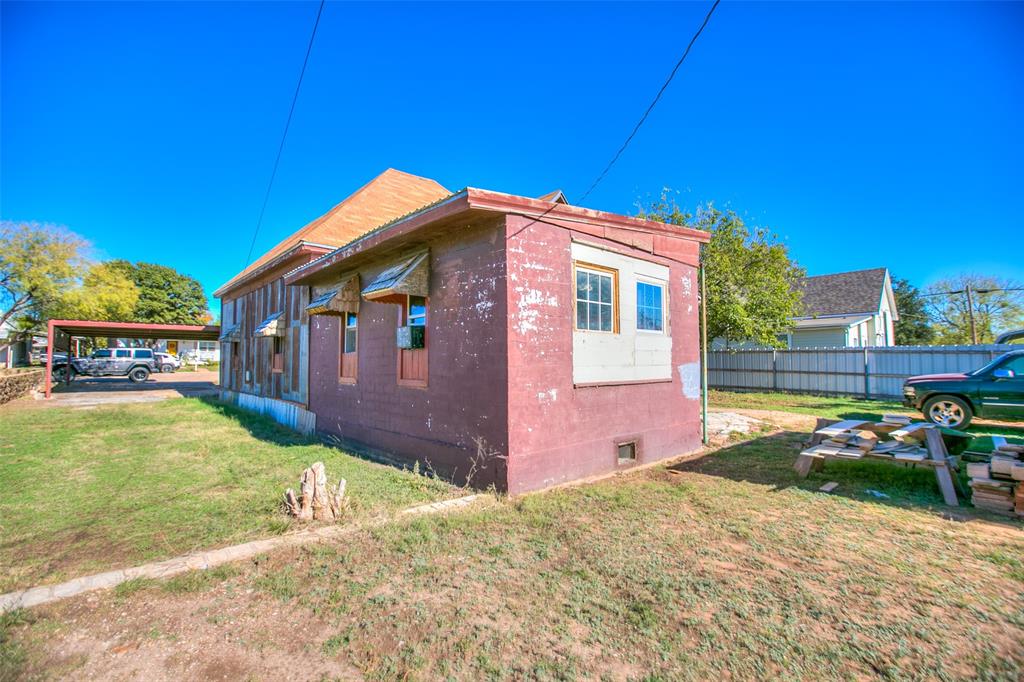 1303 North 7th Street Ballinger, TX 76821 - Photo 23 of 26 a front view of a house with a yard