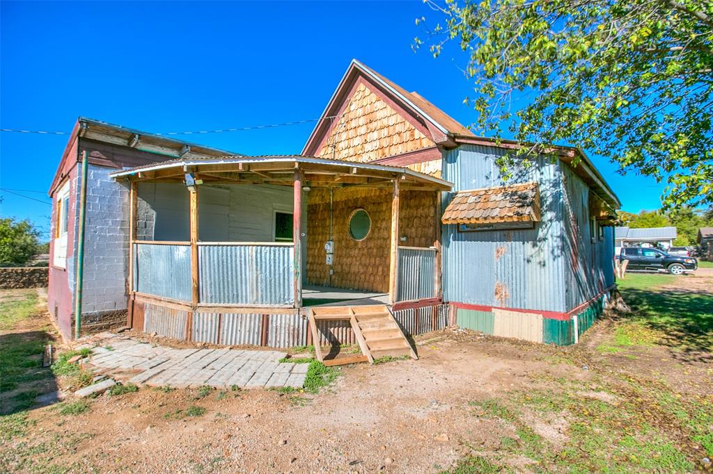 1303 North 7th Street Ballinger, TX 76821 - Photo 24 of 26 a front view of a house with a yard