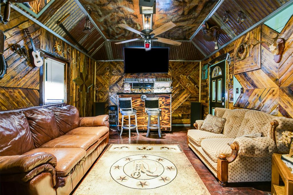 1303 North 7th Street Ballinger, TX 76821 - Photo 7 of 26 a living room with furniture and a flat screen tv