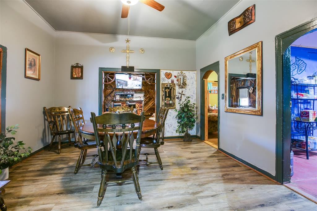 1303 North 7th Street Ballinger, TX 76821 - Photo 10 of 26 a view of a dining room with furniture window and wooden floor
