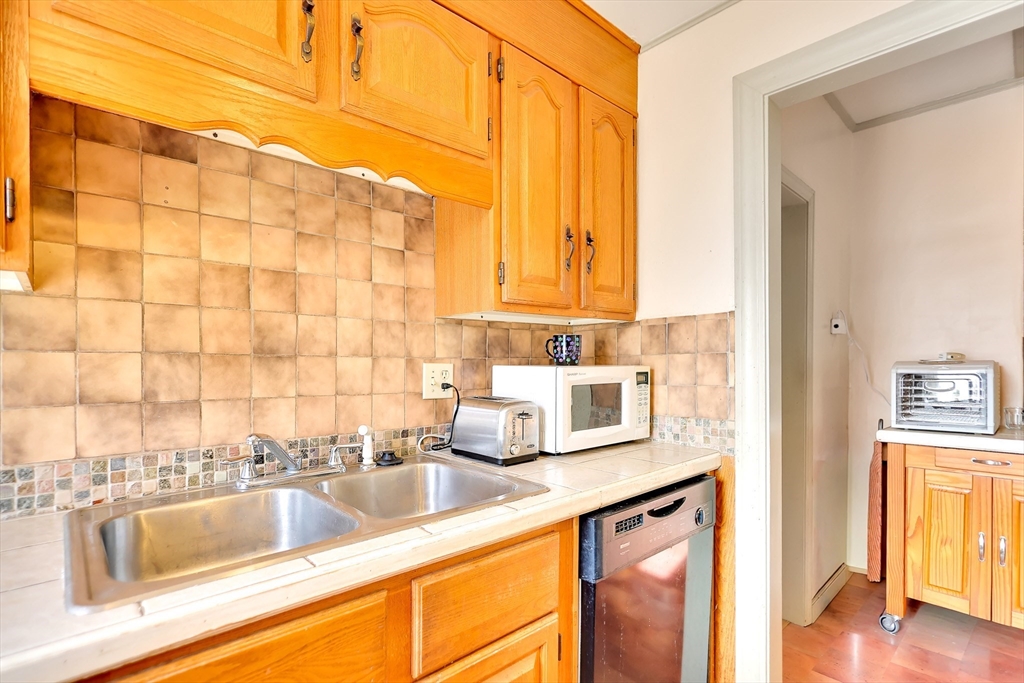 14 Tyler Street Methuen, MA 01844 - Photo 13 of 29 a bathroom with a granite countertop sink and a window