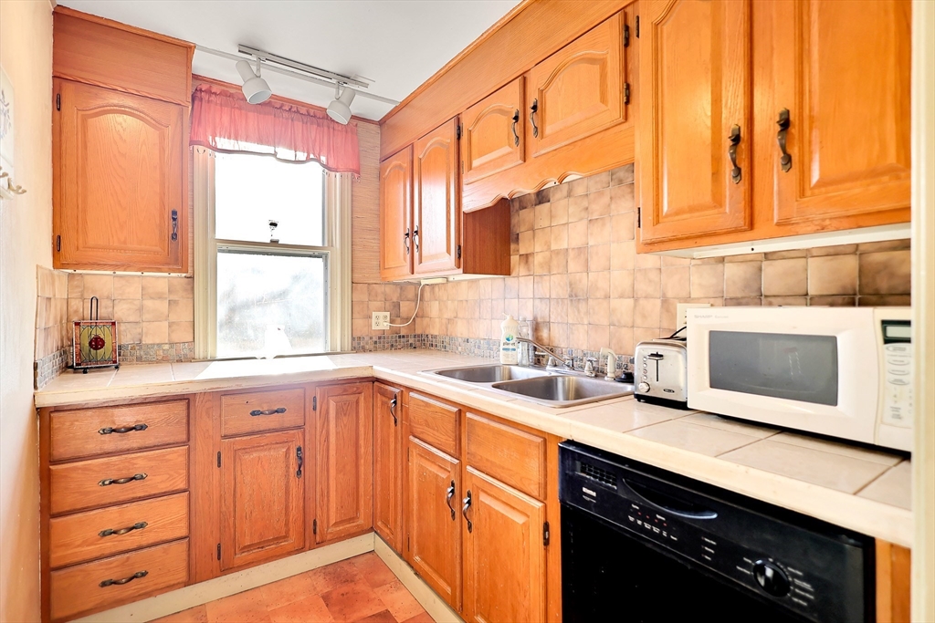 14 Tyler Street Methuen, MA 01844 - Photo 14 of 29 a kitchen with stainless steel appliances a sink a stove and cabinets