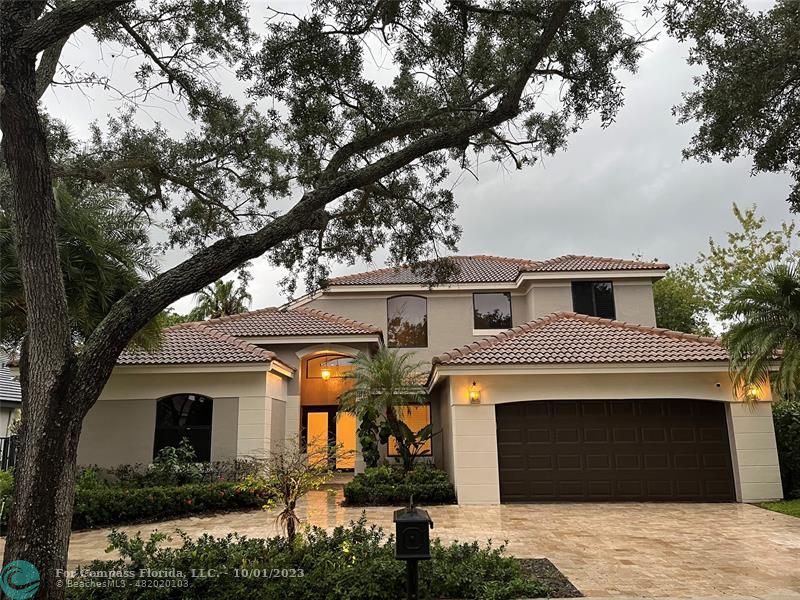 2993 Oakbrook Drive Weston, FL 33332 - Photo 3 of 11 a front view of a house with garden