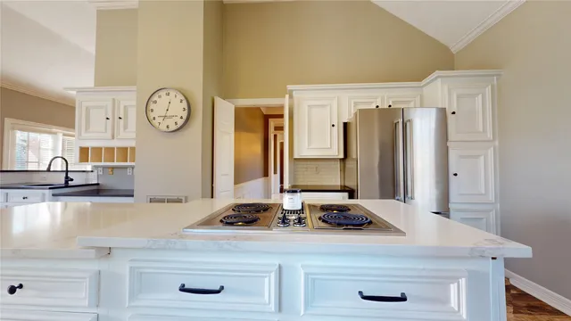 a view of a kitchen with a sink and a refrigerator
