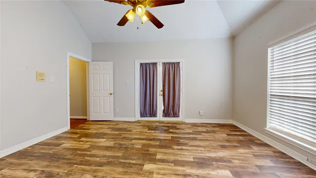 a view of a livingroom with wooden floor and window