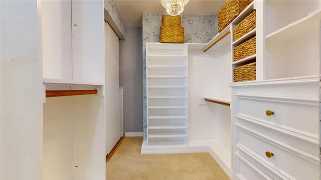 a view of walk in closet with empty racks