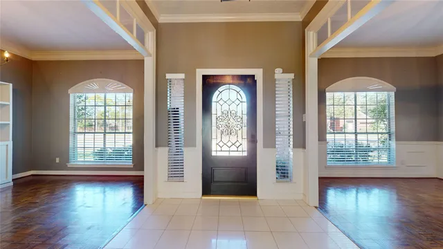 a view of a room with wooden floor and windows