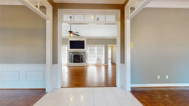 a view of a hallway with wooden cabinet