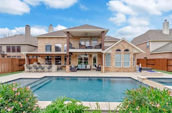 an aerial view of a house with swimming pool garden and patio