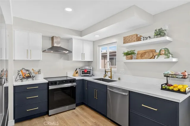 a kitchen with a sink a stove and cabinets