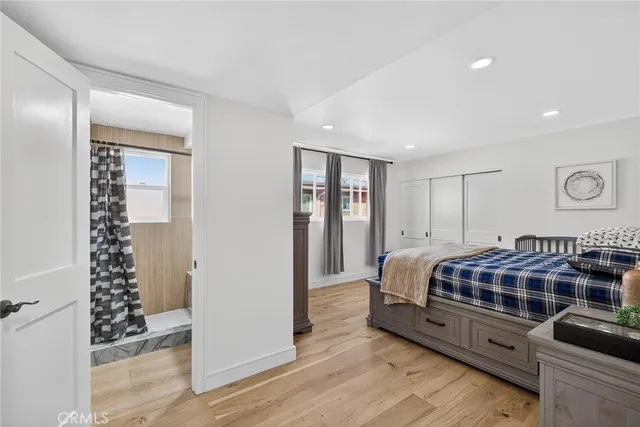 a bedroom with a bed and a mirror