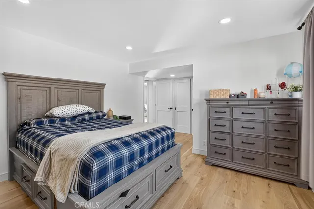 a bedroom with a bed and a dresser