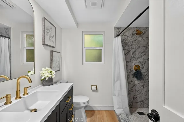 a bathroom with a sink toilet and shower