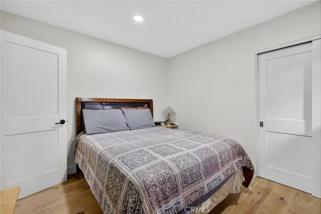 a bedroom with a bed and wooden floor