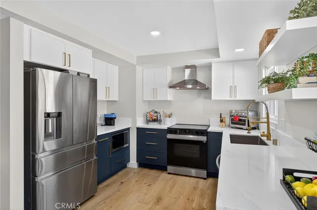 a kitchen with stainless steel appliances a refrigerator sink and stove