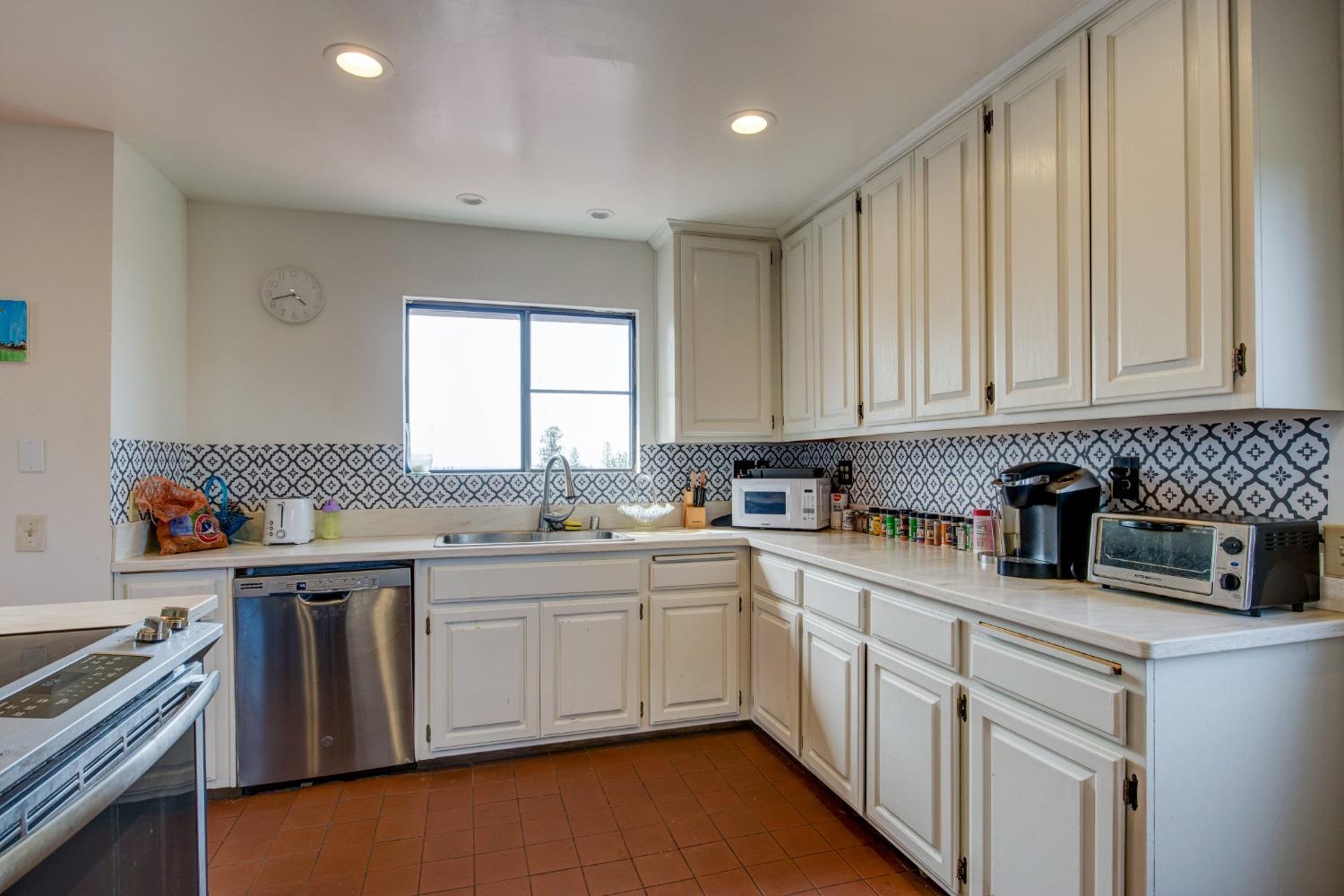 4771 Greenhills Road Placerville, CA 95667 - Photo 18 of 71 a kitchen with a sink stove and cabinets