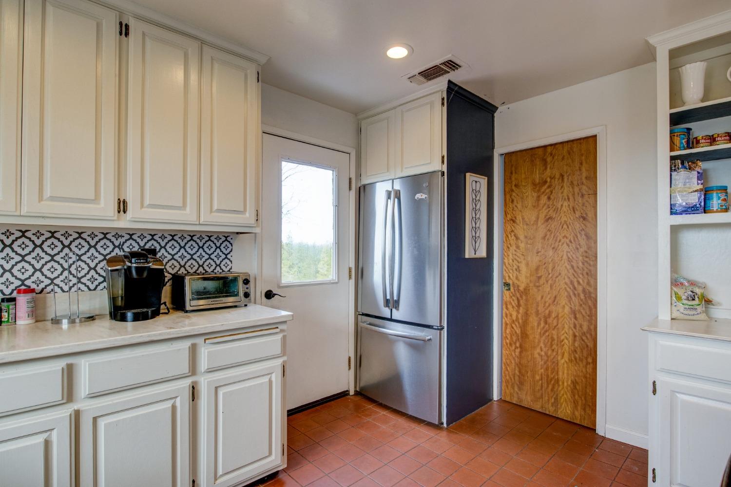 4771 Greenhills Road Placerville, CA 95667 - Photo 19 of 71 a kitchen with a refrigerator and cabinets