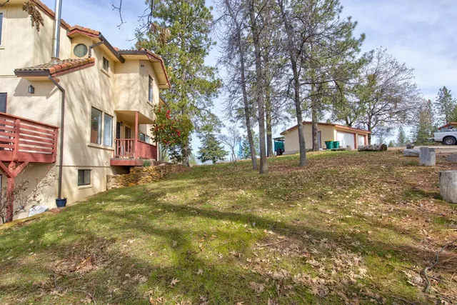 a view of a yard with swimming pool and trees