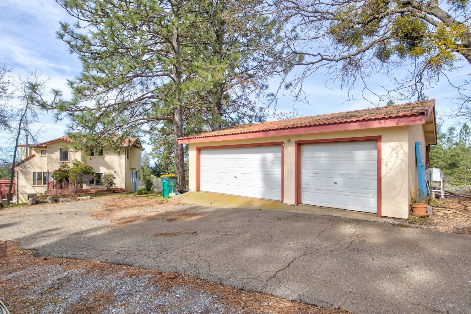 4771 Greenhills Road Placerville, CA 95667 - Photo 54 of 71 a front view of a house with a yard and garage